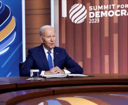 Biden sees 'turning point' for democracy, offers funding push